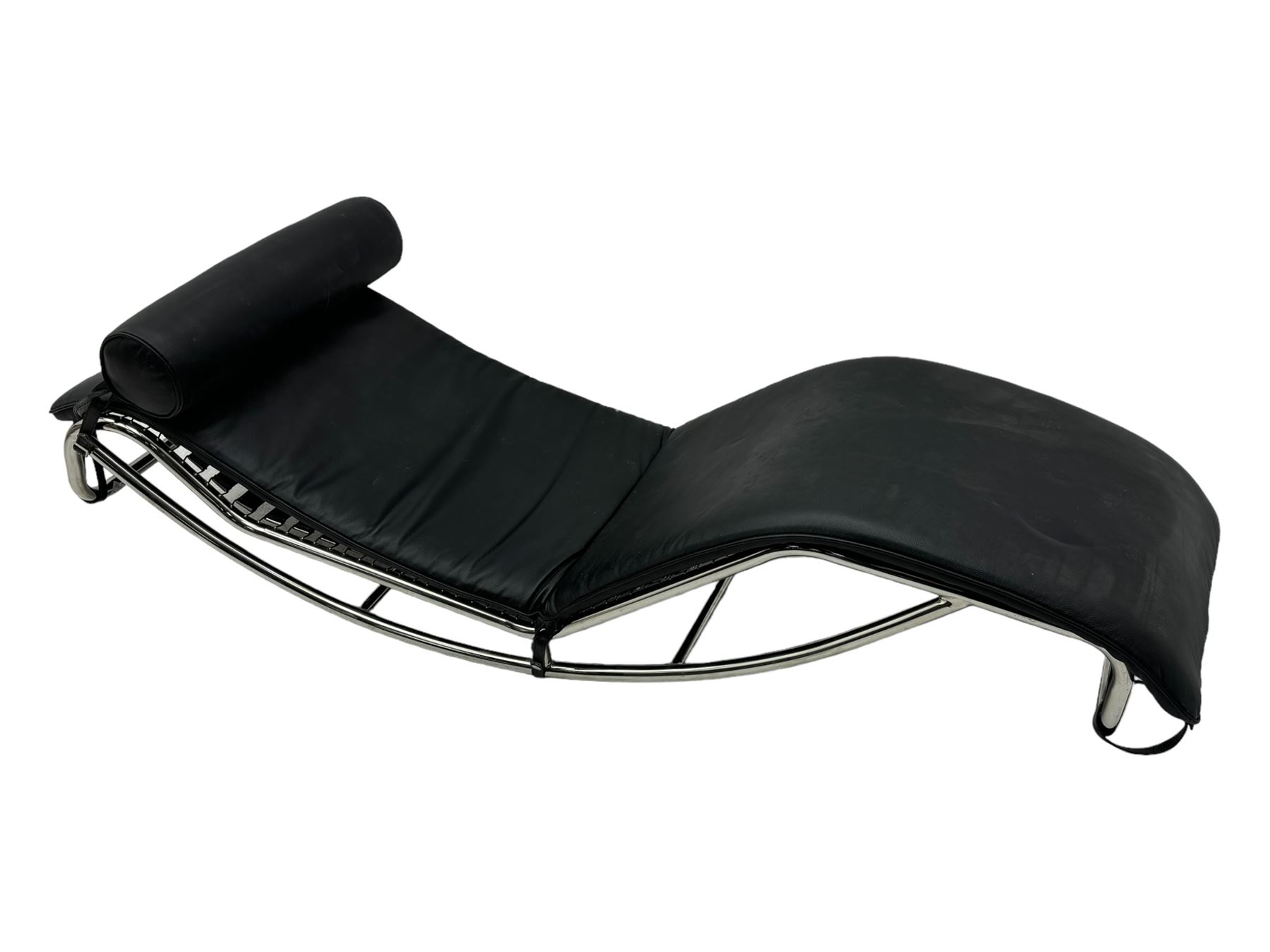 After Le Corbusier, Pierre Jeanneret, and Charlotte Perriand - LC4 chaise longue, black leather upholstery with cylindrical headrest, supported by a chromed tubular steel frame, with cantilever design with elastic webbing