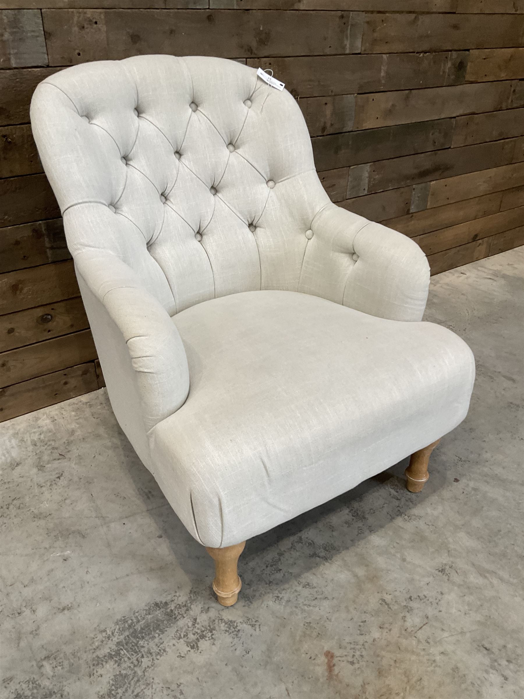 Armchair upholstered in button back linen fabric