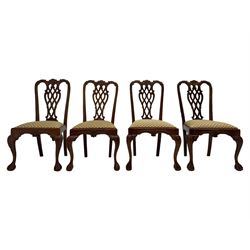 Set of twelve Chippendale design mahogany dining chairs, shaped cresting rail carved with foliage and C-scrolls, pierced interlaced splat with curled leaf decoration, upholstered drop-in seat, moulded seat rails, on scrolled acanthus carved cabriole supports with ball and claw feet 