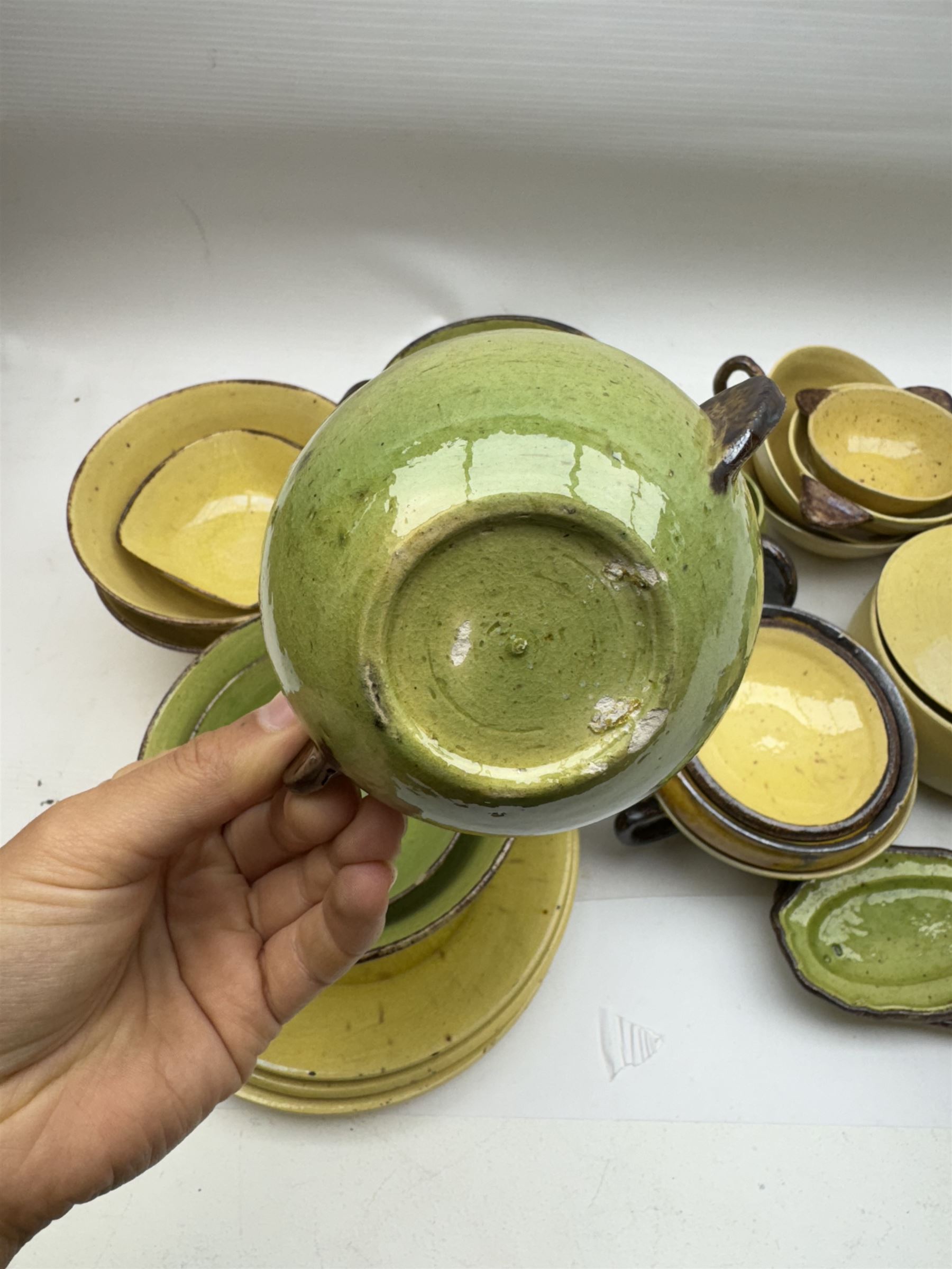 French green and yellow glazed tea and dinner wares by Etienne Noel, including milk jugs, teacups, side plates, bowls etc (43)