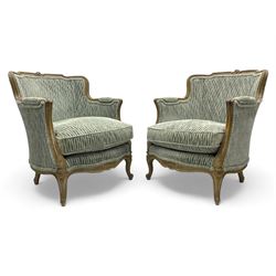 Colefax and Fowler - pair of French design beech framed armchairs, the moulded frame and cresting rail carved with flowers, scrolled arms and serpentine seats, cabriole supports with scroll carved terminals, upholstered in Colefax and Fowler fabric