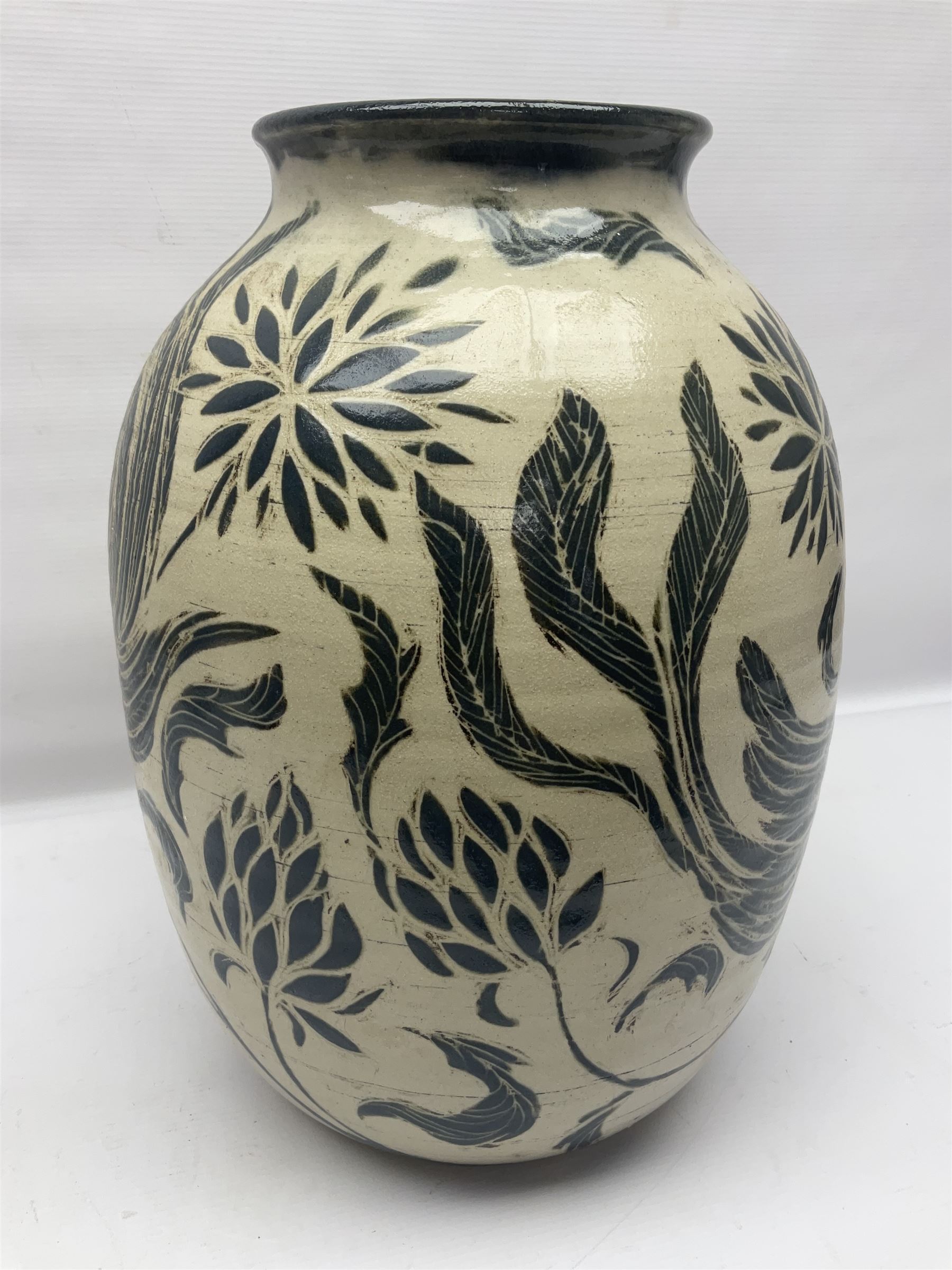 John Egerton (c1945-): studio pottery stoneware vase decorated with birds in flowers braches upon a white ground, H40cm