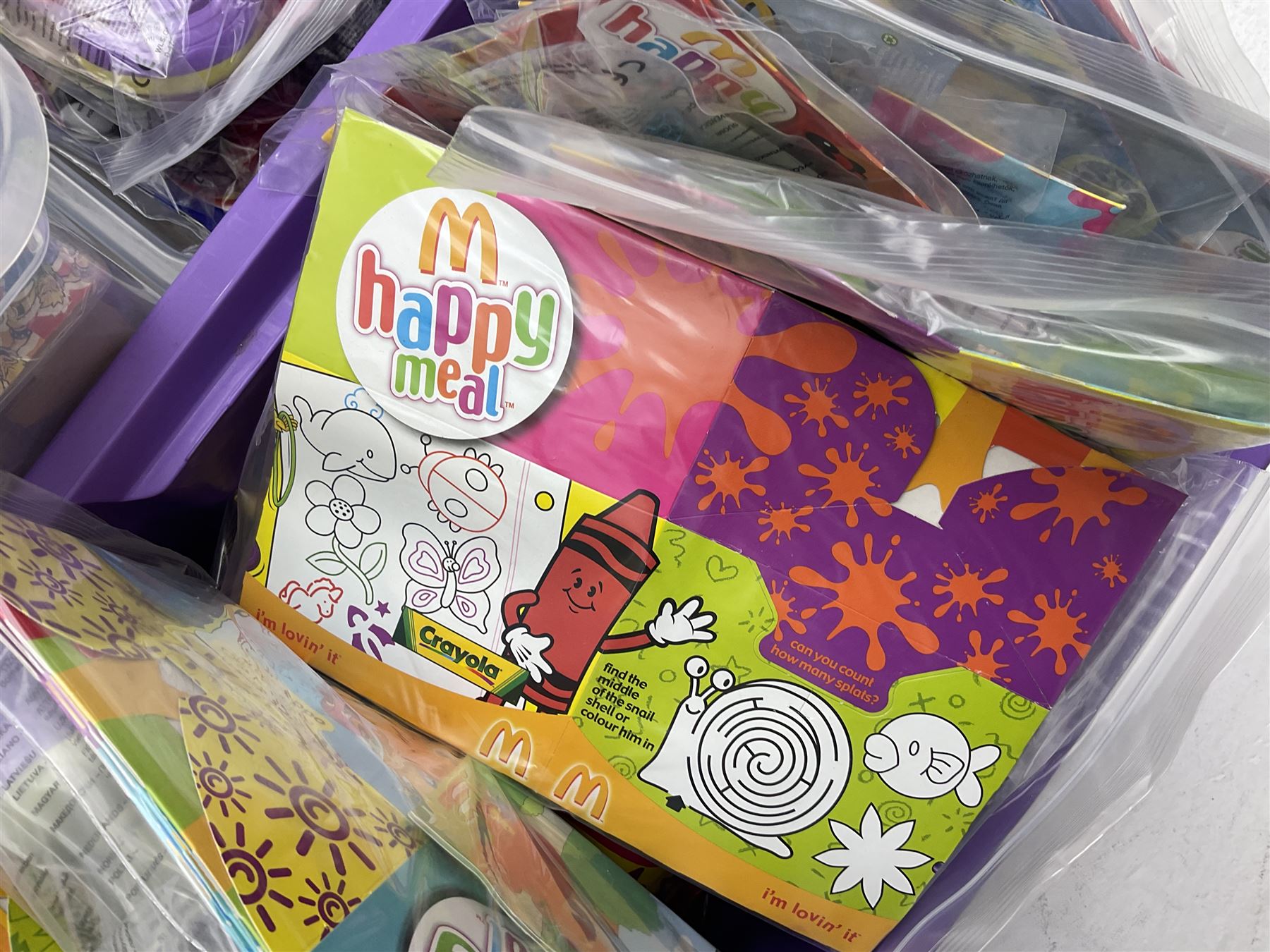 Large quantity of Mcdonalds toys to include Herbie and Polly Pocket in three boxes