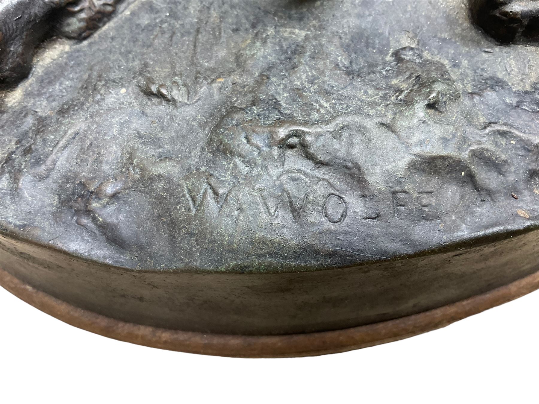 After W. Wolfe; bronze cast figural group depicting bullmastiff feeding puppies, signed with impressed mark to the front, on oval wooden base, H20cm