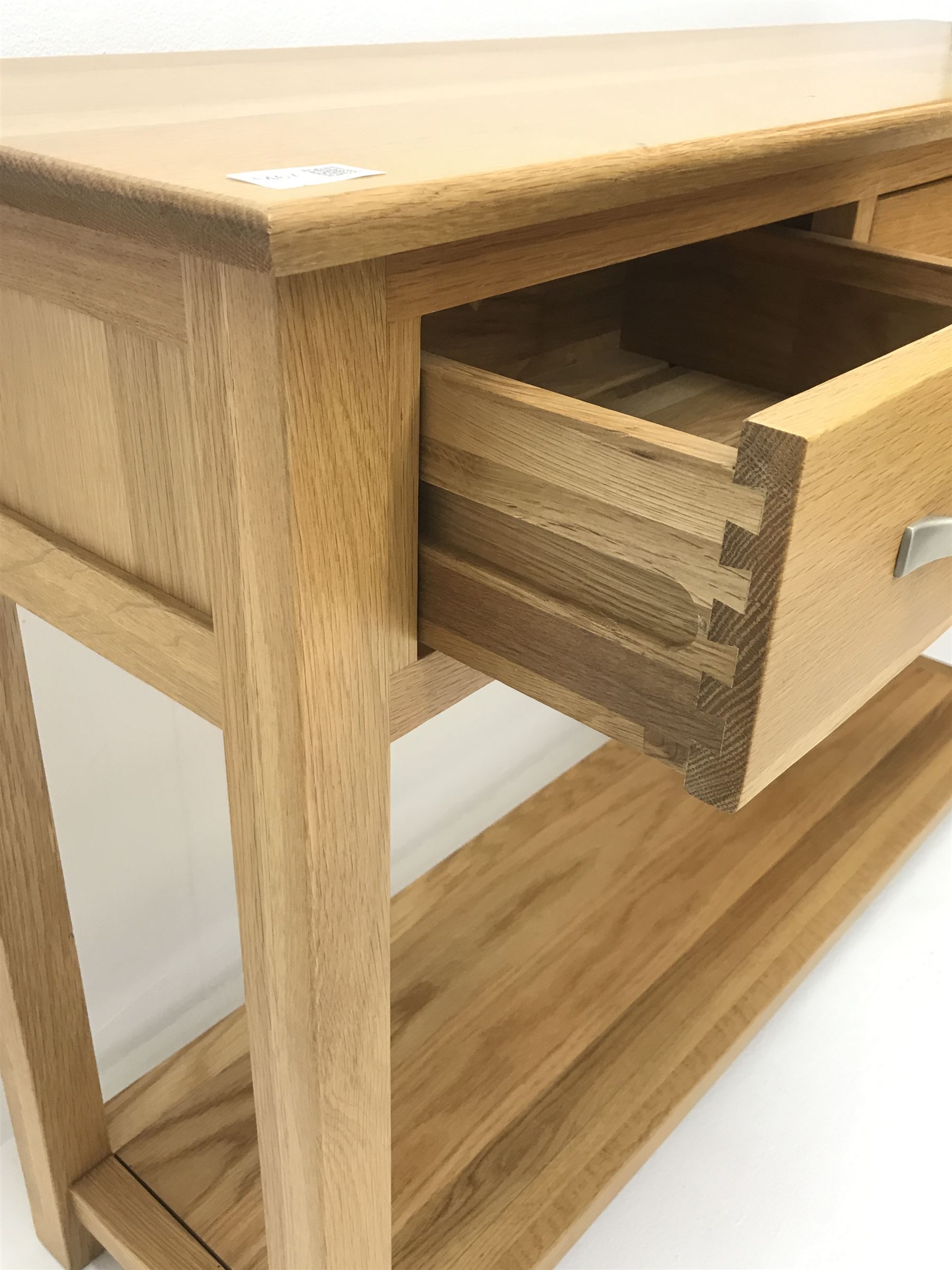 Light oak side console table, three drawers, square supports joined by solid undertier