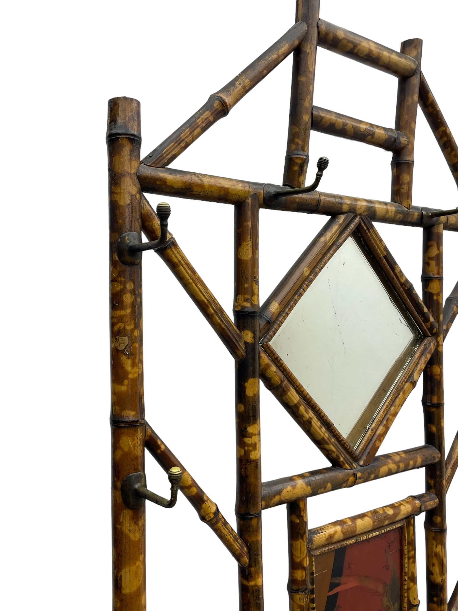 Victorian bamboo hallstand, bevelled mirror over red lacquered and chinoiserie decorated panels, fitted with six brass hooks 