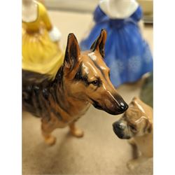 Three Royal Doulton figures, to include Nina, Clarissa and Coralie, together with a Royal Doulton Alsation figure and a Branksome boxer dog figure