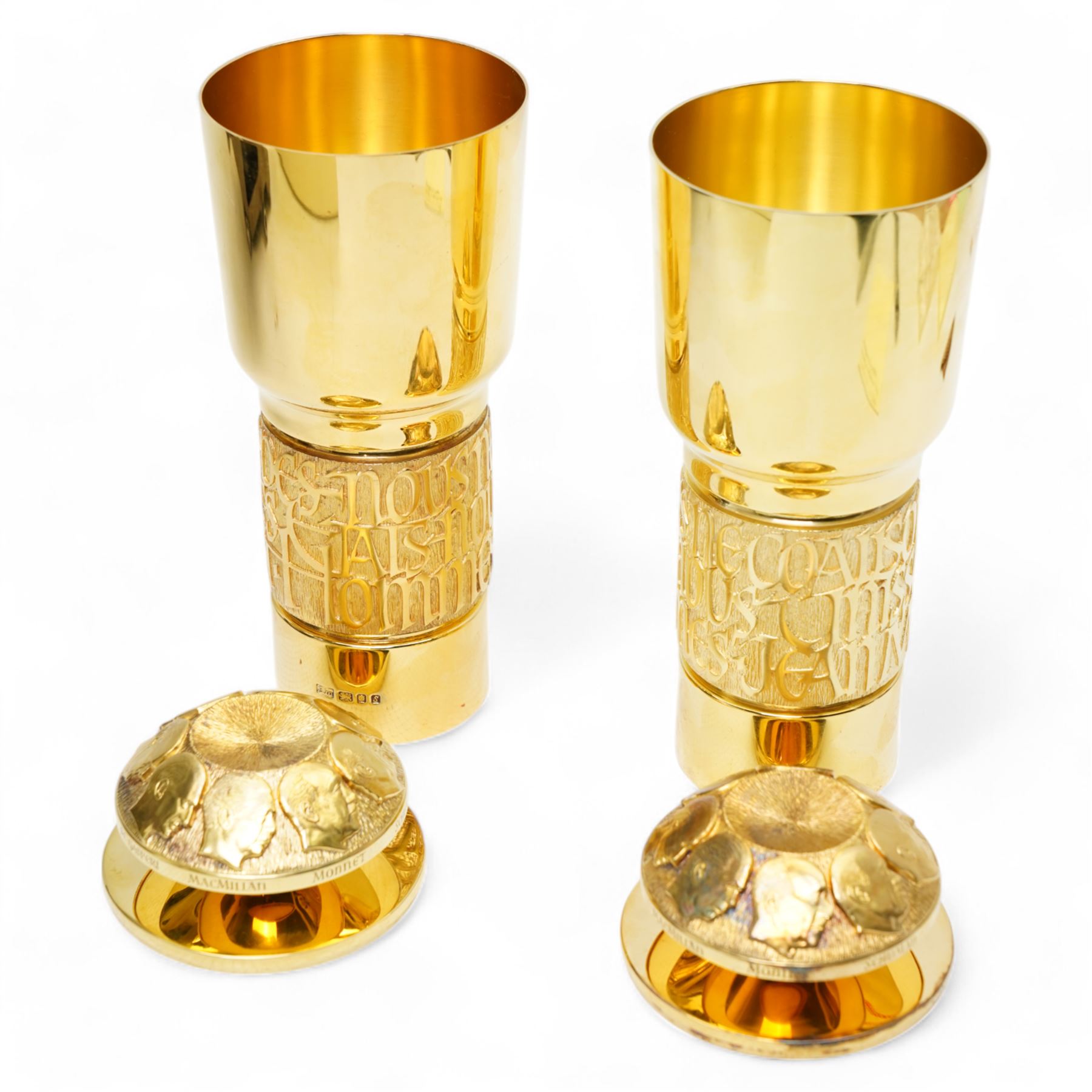 Pair of limited edition silver gilt 'The Congress of Europe Standing Cups and Covers', commemorating Jean Monnet's services to the cause of European Unity, designed by Hector Miller and Madeleine Dinkel for Aurum, the lids bearing carved portraits of eight statesmen including Adenhauer, Churchill, Macmillan and others, the bands of calligraphy in high relief quoting Monnet, no. 37 and 36/100, hallmarked Aurum, London 1973, H21cm, with certificates and original case