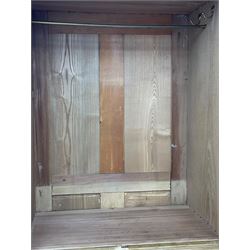 Late 19th century ash combination wardrobe, projecting cornice over foliage carved frieze, the left-hand upright enclosed by mirror glazed door, the right-hand side fitted with double panelled cupboard over two short and three long drawers, the upper panels carved with curled leaves and central scroll cartouche, on bracketed plinth 