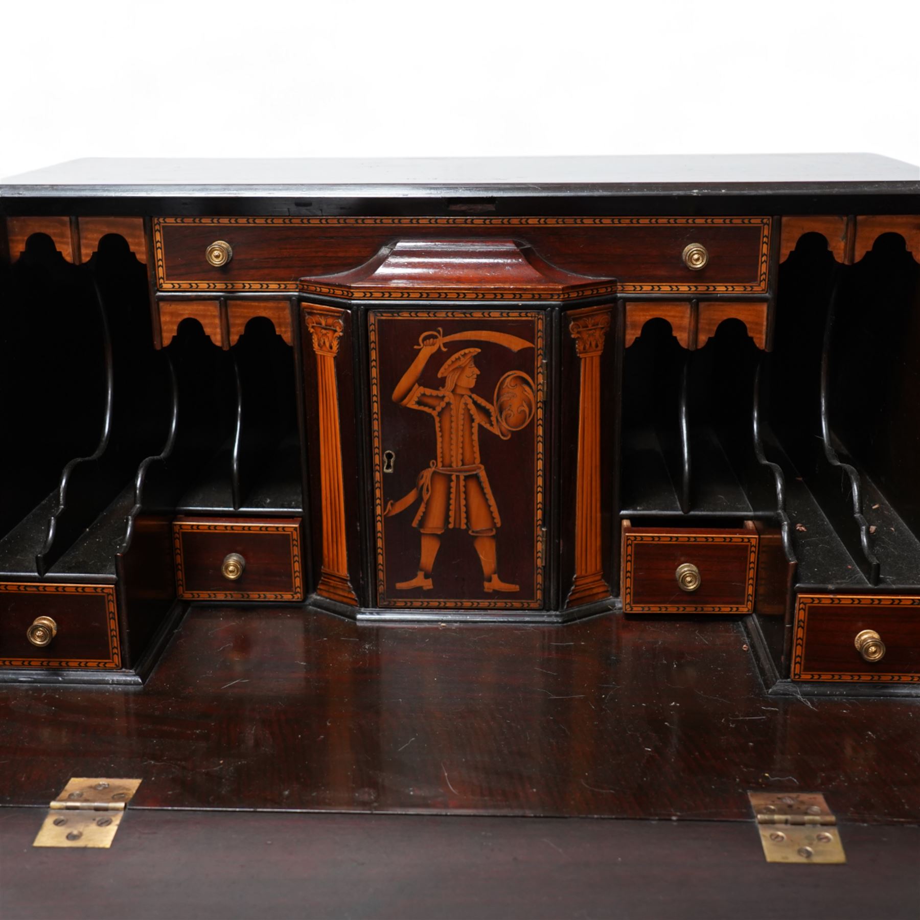 19th century inlaid mahogany bureau on stand, sloped moulded lid inlaid with shell motifs and parquetry bands, the interior fitted with drawers, small cupboard and document divisions, inlaid with soldier holding sword and shield flanked by classical columns, the stand fitted with single drawer over shaped apron inlaid with shell, on square tapering supports  