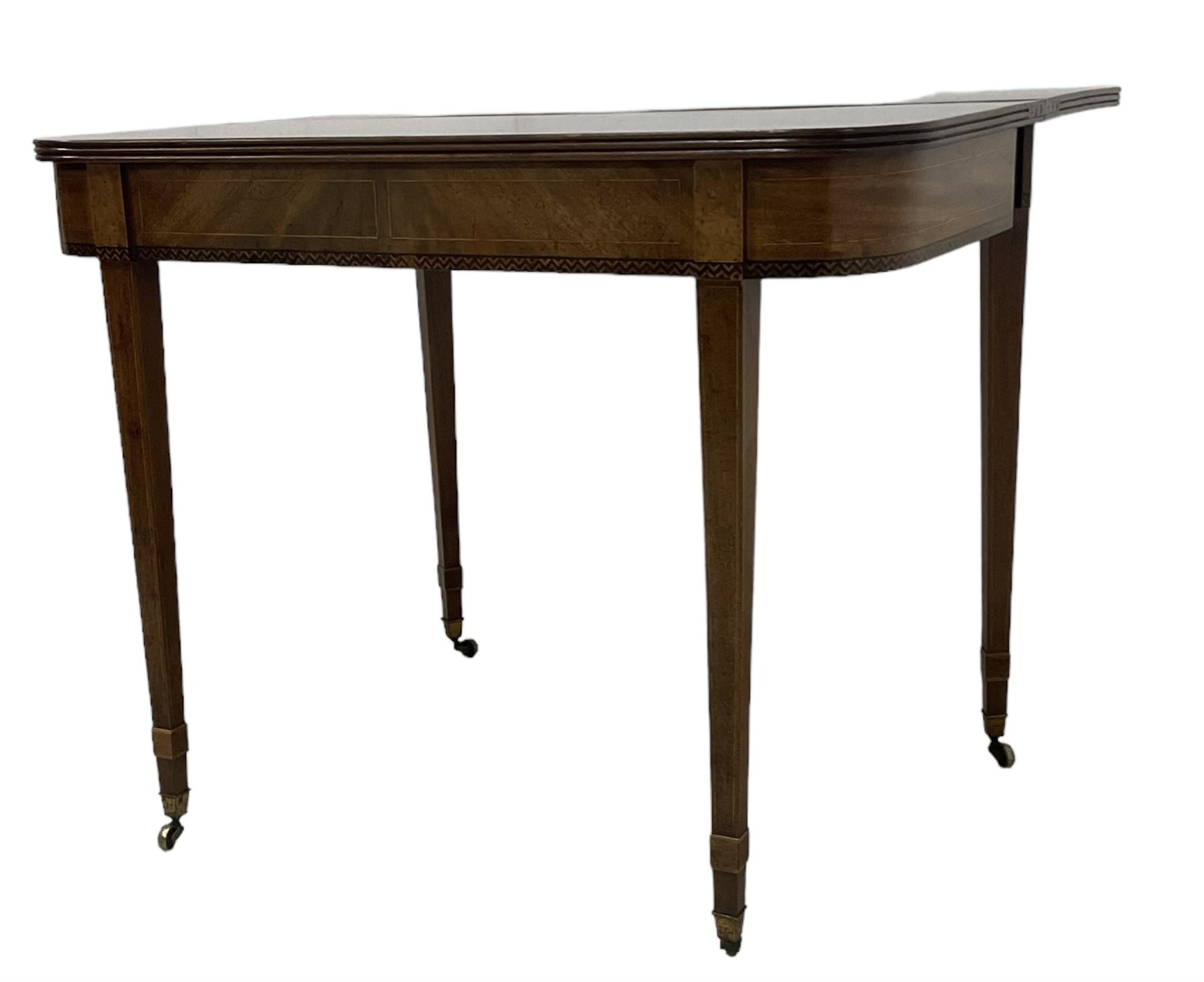 19th century mahogany tea table, fold-over top with reeded edge over inlaid frieze, on double gate-leg action square tapering supports, with brass castors