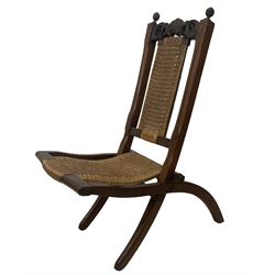 Victorian Aesthetic Movement mahogany framed folding campaign chair, pierced and carved cresting rail with carved and chamfered uprights, rattan back and seat