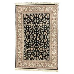 Persian design dark indigo ground rug, the field decorated with trailing branches and foliate motifs, repeating scrolling border with stylised plant motifs