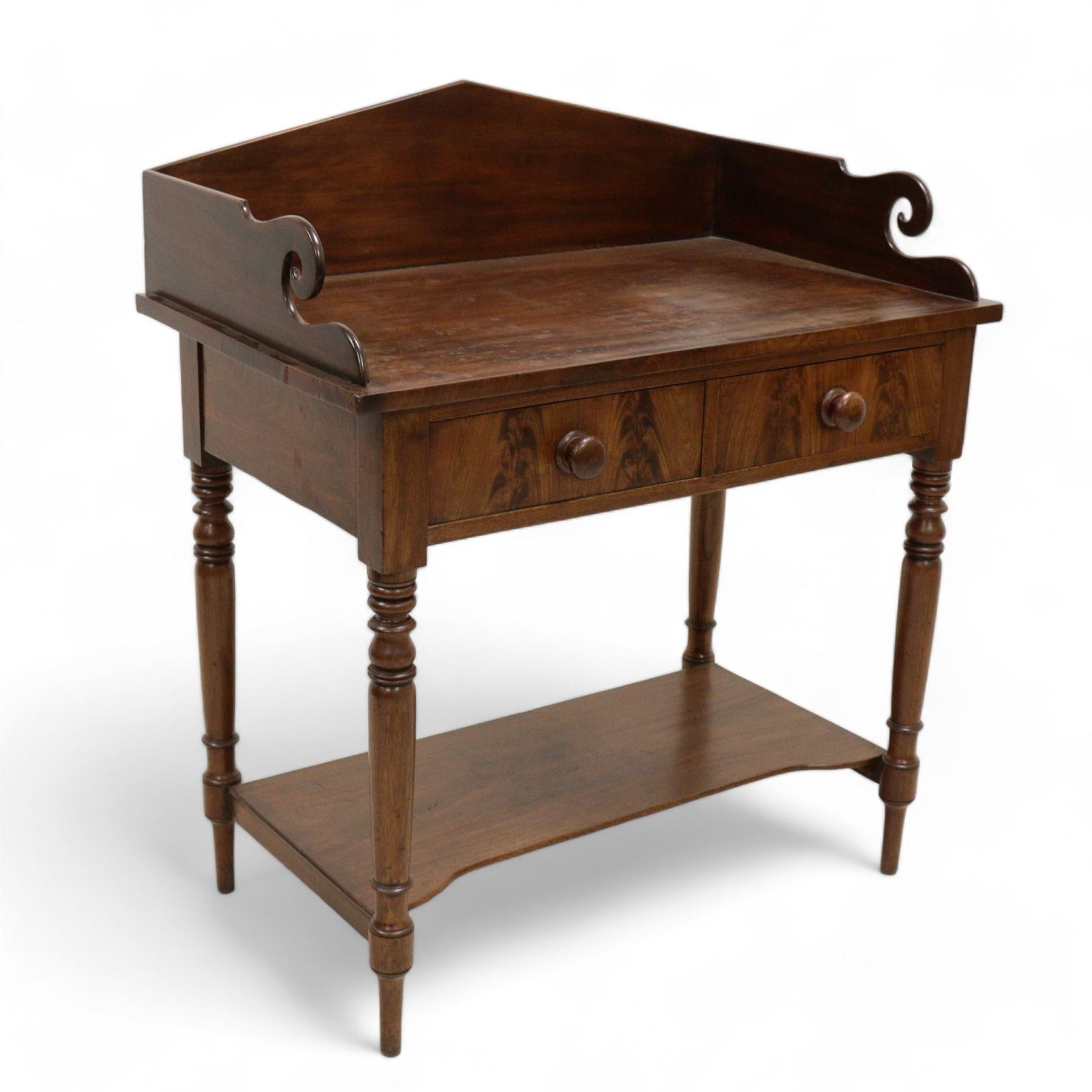 Early Victorian mahogany wash stand, pointed and sloped arch back with shaped and pierced scroll returns, rectangular top over two drawers, on turned supports united by undertier 