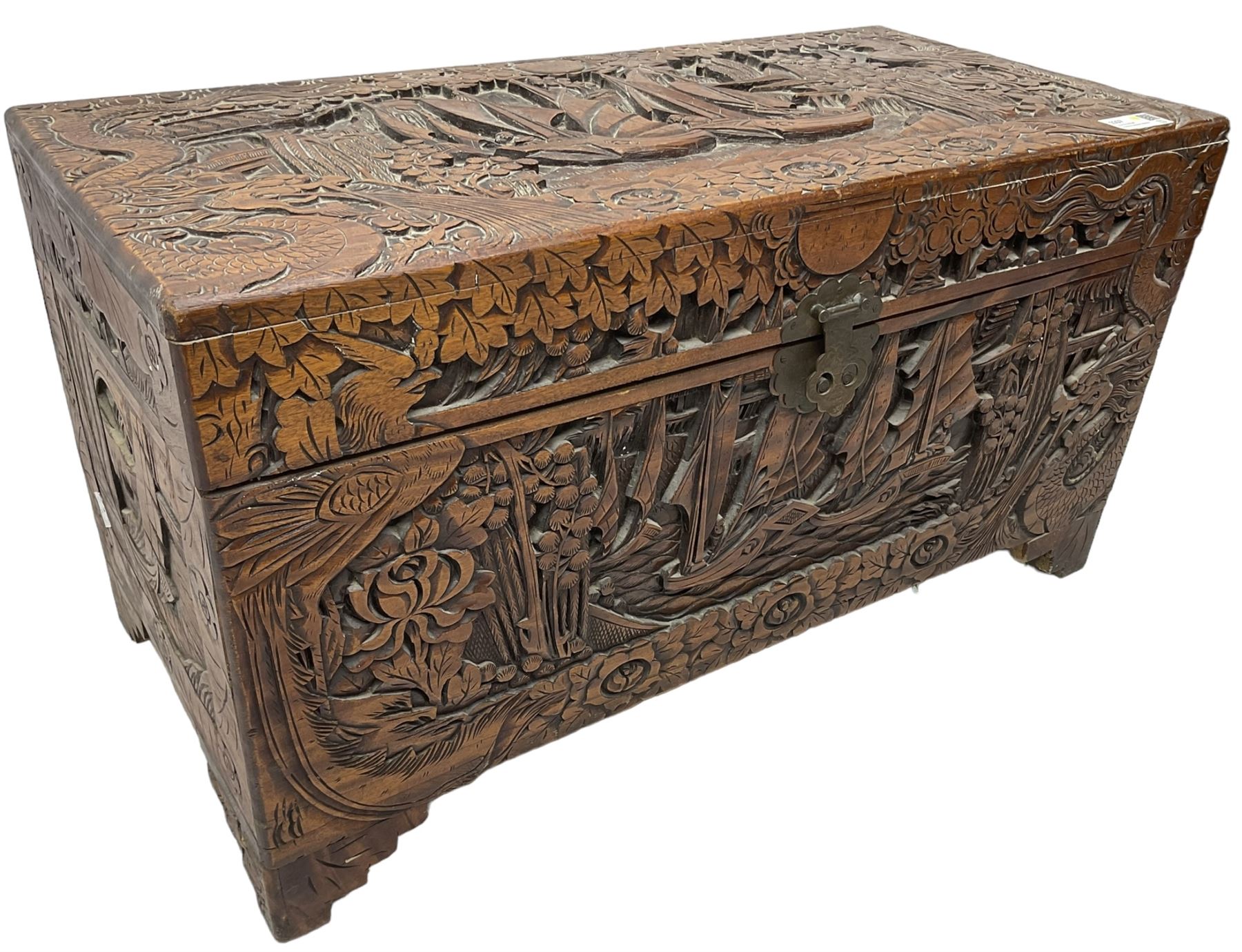 Chinese carved camphor wood blanked chest, rectangular hinged top, carved all over with traditional dragon motifs and junk ships