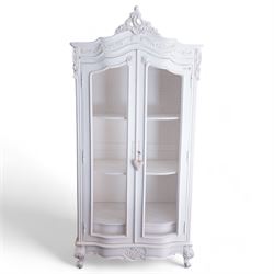 French design white painted and carved armoire, arched pediment with moulded scrolling foliate decoration, fitted with two wire-work doors enclosing three shelves, raised on acanthus carved cabriole feet