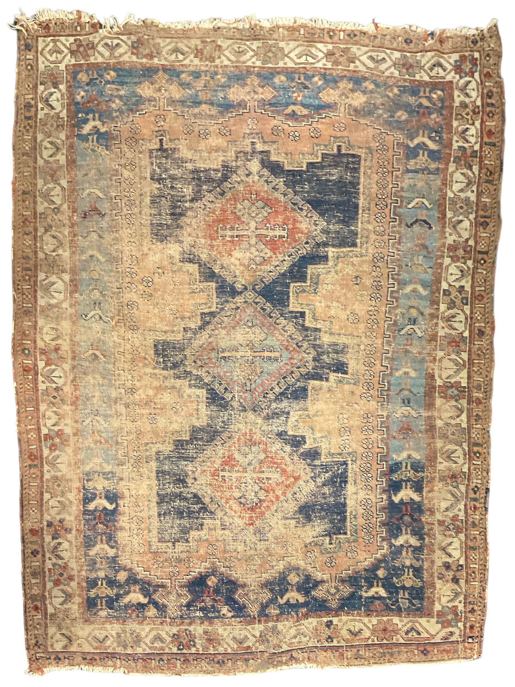 Antique Caucasian rug, indigo ground field decorated with three lozenge medallions within borders of stylised bird and flower head motifs