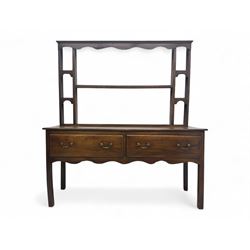 George III oak dresser, projecting cornice with scalloped frieze over shaped plate rack wi...