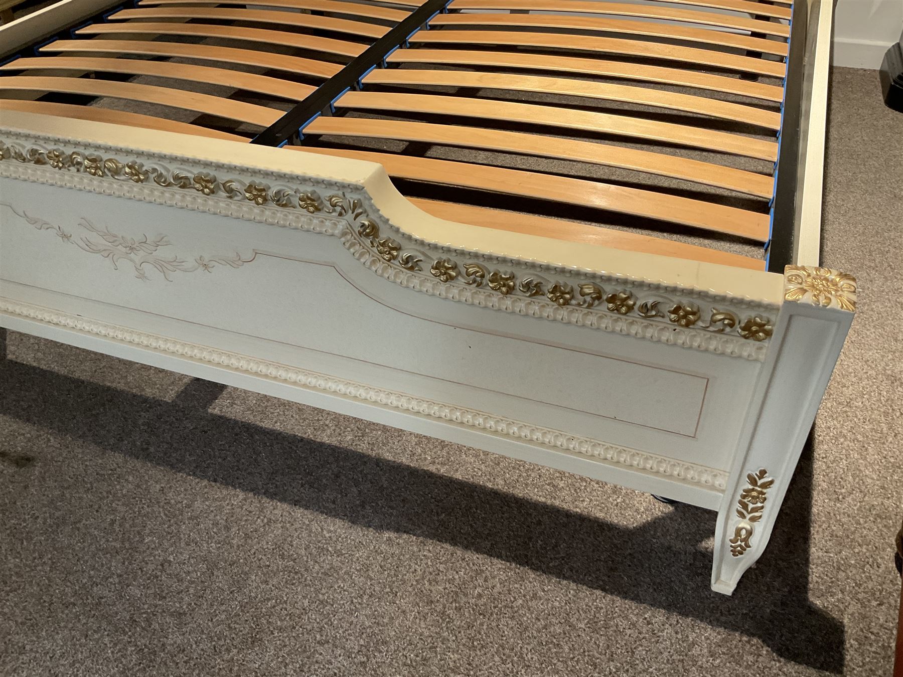 Barnini Oseo - super king 6' 'Reggenza' bedstead, the headboard with a pierced cartouche pediment with extending scrolling foliage, decorated with trailing gilt flower heads, upholstered in buttoned lilac velvet, raised on cabriole feet, in a cream finish