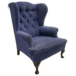 Early 20th century wingback armchair, upholstered in buttoned blue fabric, rolled and scrolled arms, on cabriole feet