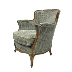 Colefax and Fowler - pair of French design beech framed armchairs, the moulded frame and cresting rail carved with flowers, scrolled arms and serpentine seats, cabriole supports with scroll carved terminals, upholstered in Colefax and Fowler fabric