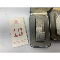 Three Dunhill silver plated lift-arm lighters, of rectangular form with engine turned decoration, marked Dunhill, two with original cases 