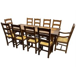 Antix Furniture - oak extending refectory dining table, rectangular plank top with two additional leaves and two drawers to the longer side, on square supports connected by H-stretcher; set of ten (8+2) ladder back dining chairs with rush seats