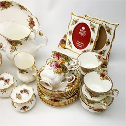 A Royal Old Country Roses teaset, comprising teapot, six teacups, six saucers, six side plates, milk jug, open sucrier, and cake plate, plus a large bowl, jug, pair of jars and covers, pair of photograph frames, 1980 calendar plate marked first edition, and five cloth napkins. 