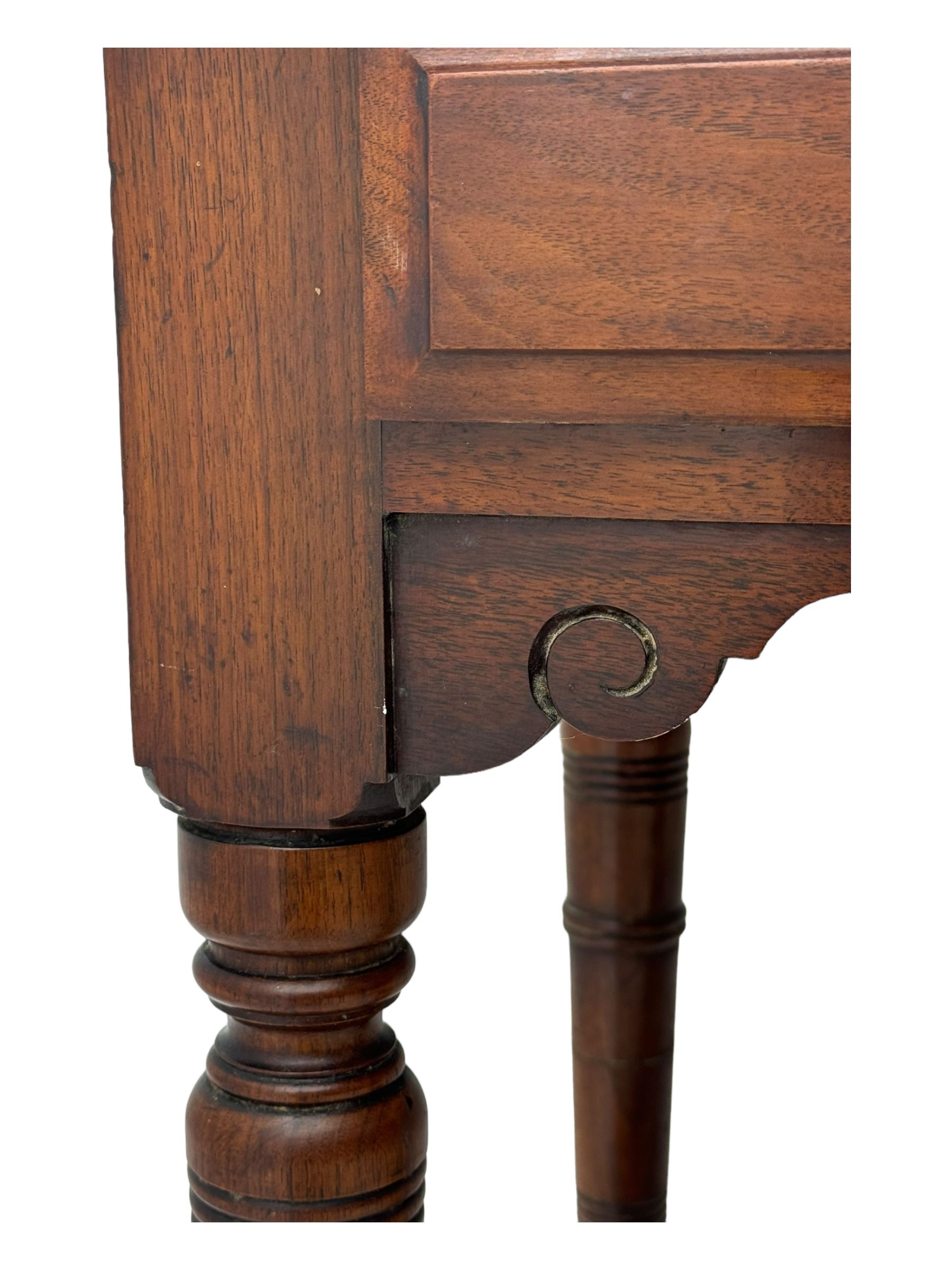 Late Victorian walnut dressing table, raised bevelled swing mirror over small trinket drawers, rectangular moulded top, fitted with two drawers, on turned supports united by undertier 