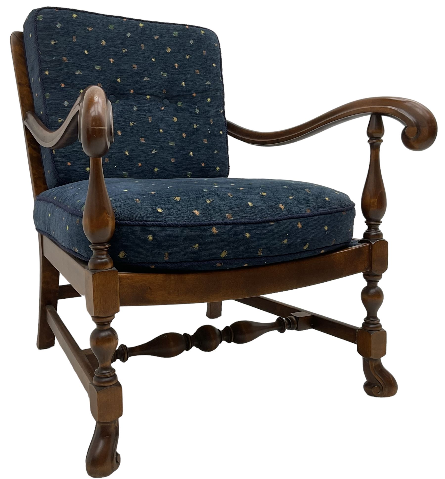 Early 20th century stained beech framed armchair, cane panel back over scrolled arm terminals, raised on turned supports united by turned H-stretcher, with patterned blue upholstered loose back and seat cushions