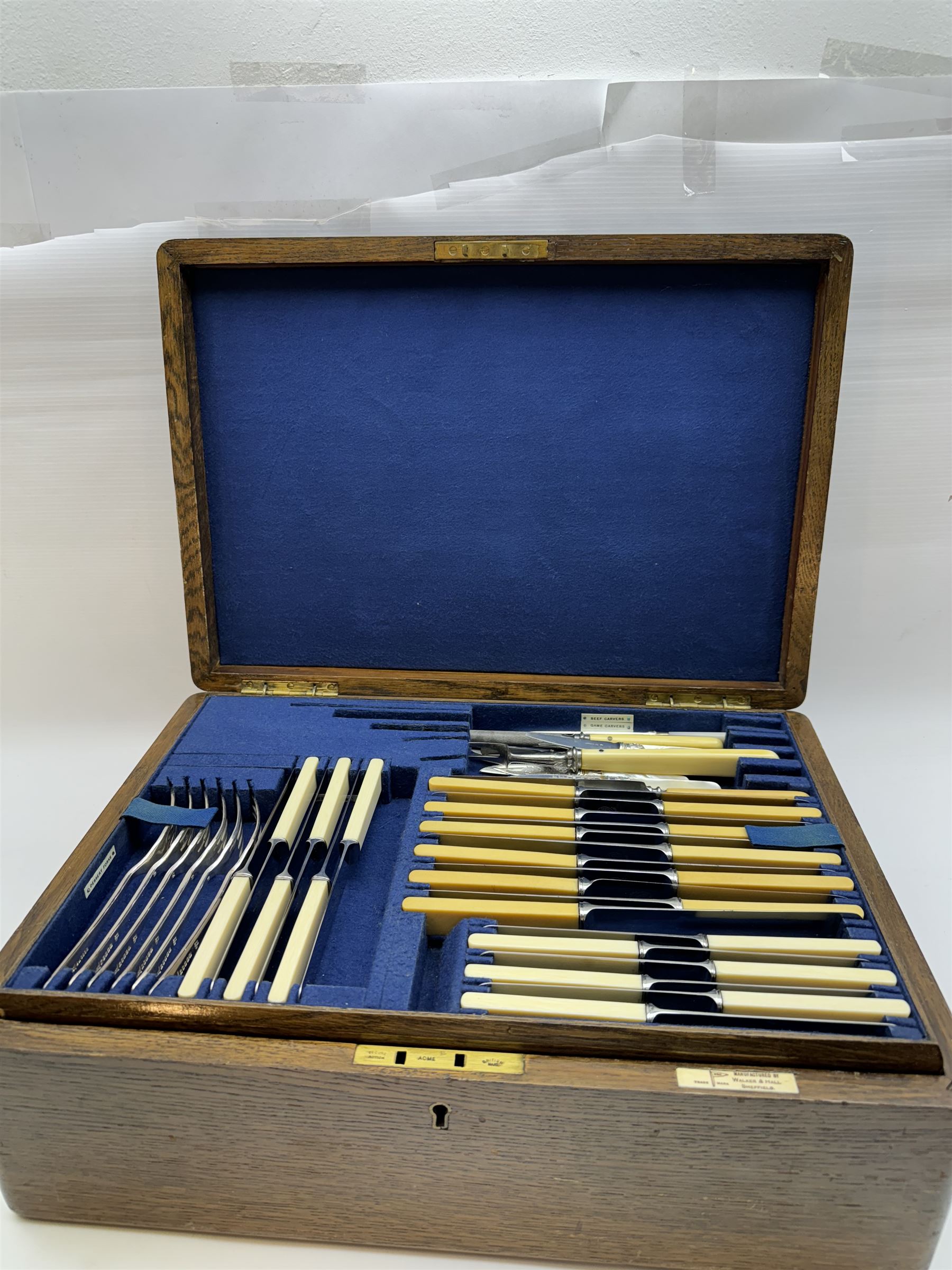 Walker & Hall canteen of plated cutlery for for twelve place settings, all knives with ivory effect handles, within an oak canteen case with a brass shield to the lid, with key, case  