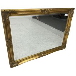 Swept gilt framed wall mirror with rectangular bevelled plate