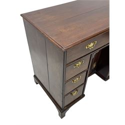 George III mahogany kneehole desk, moulded rectangular top over one long drawer, six short drawers and recessed panelled cupboard, cock-bead moulded frame, fitted with shaped brass handle plates with engraved decoration, on bracket feet 