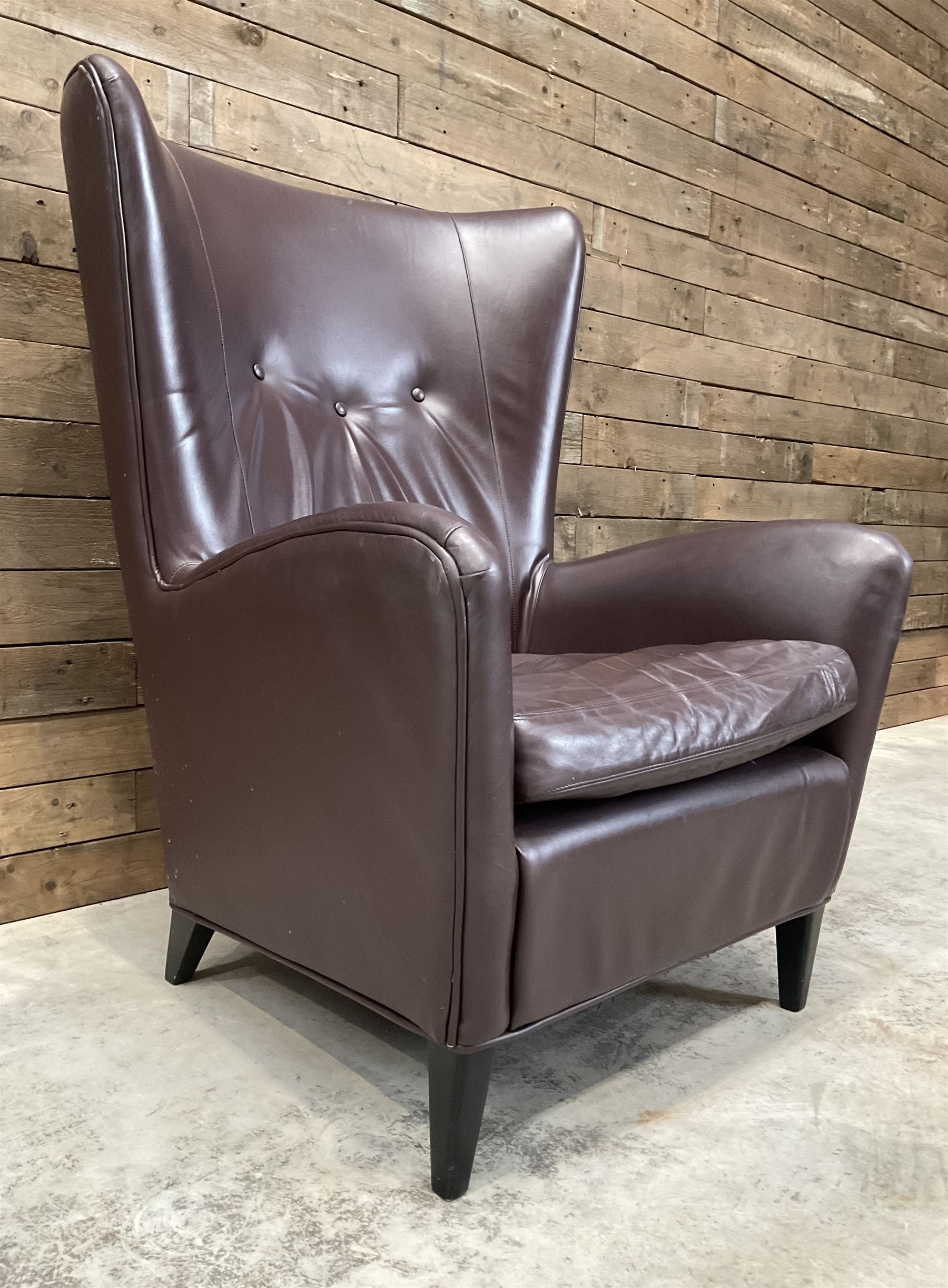 Wing back armchair upholstered in cocoa brown leather