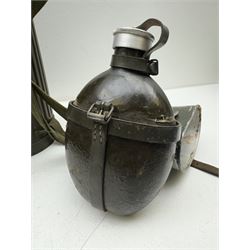 Two WWII German army canteen water bottles, together with German gas mask marked FE55 in a green fluted tin canister