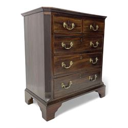 Small George III mahogany chest, rectangular canted form, moulded top over two short and three long cock-beaded drawers, fitted with brass swan neck handles and oval plates, enclosed by fluted upright corners, on bracket feet 