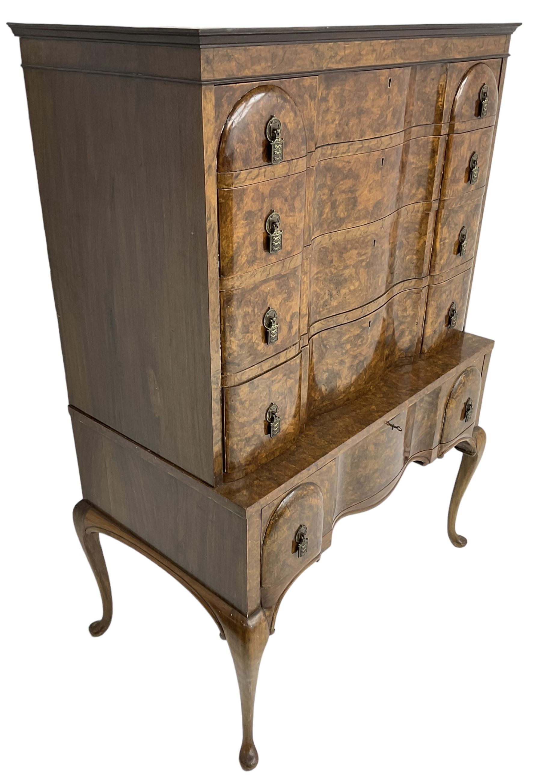 Early to mid-20th century figured walnut chest on stand, four graduating drawers on stand fitted with single drawer, drop handles in the form of shields with three recumbent lions, on cabriole supports