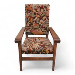 Arts & Crafts period oak framed open armchair, upholstered in needlework cover decorated with stylised floral motifs and birds, projecting arms with rolled terminals, on turned tapering supports united by plain stretcher 