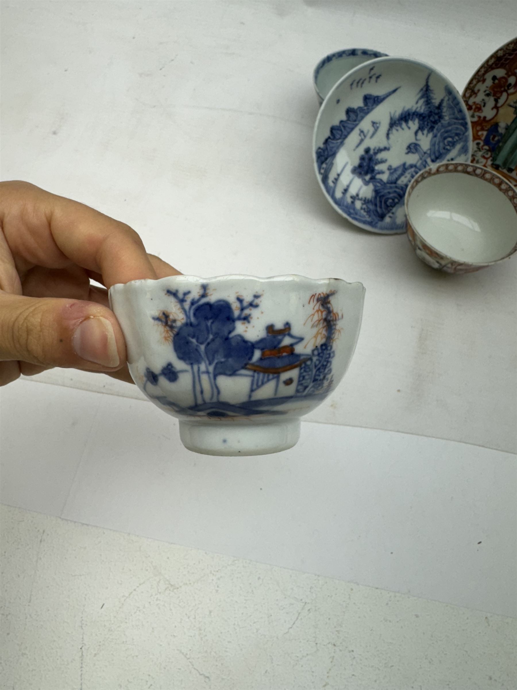 19th Century Chinese tea bowl and saucer, decorated with figures in a garden scene, together with tow other tea bowls and a saucer 