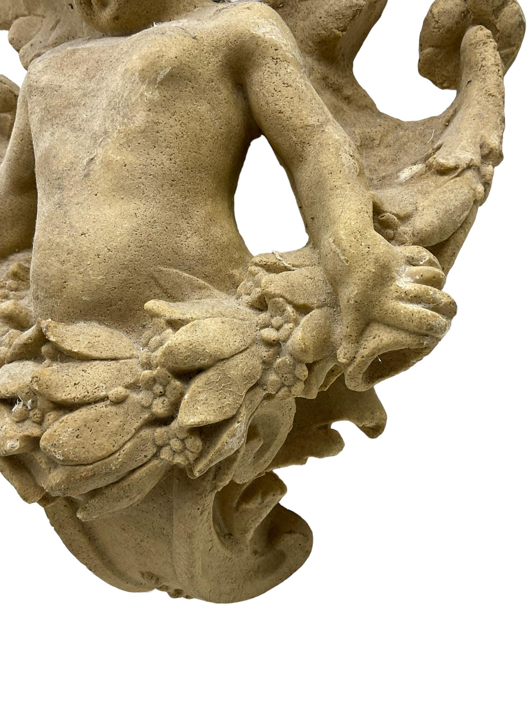 Sandstone finish moulded fibre-glass wall mounting figure of a winged cherub