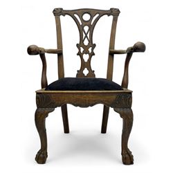 Unusual 18th century mahogany elbow chair, the shaped cresting rail with projecting shell carved ears, pierced and scroll carved splat over drop-in upholstered seat, shaped arms with ball and claw carved terminals, the seat rails carved with shell cartouches, on foliate carved cabriole supports with ball and claw feet 