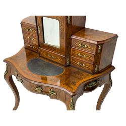 19th century French figured walnut Bonheur de Jour or writing desk, the upper section with brass gallery over mirror glazed cupboard and a combination of drawers, shaped and moulded top with leather inset and satinwood band, fitted with single drawer, on cabriole supports, inlaid throughout with scrolling foliate decoration in boxwood, ornate cast brass mounts 