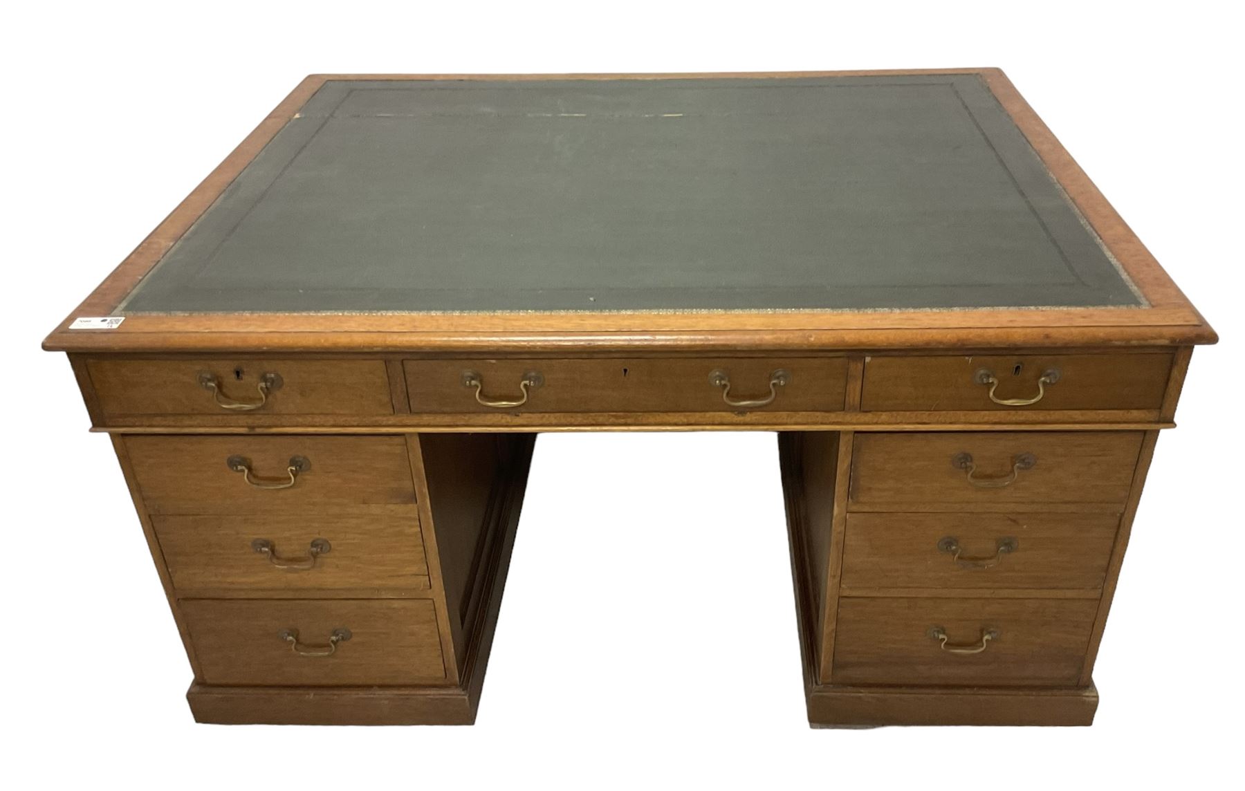 Late 19th century twin pedestal oak partner's desk, rectangular top with inset green leather writing surface, fitted with nine graduating drawers to each side, the rear drawers enclosed by panelled cupboards