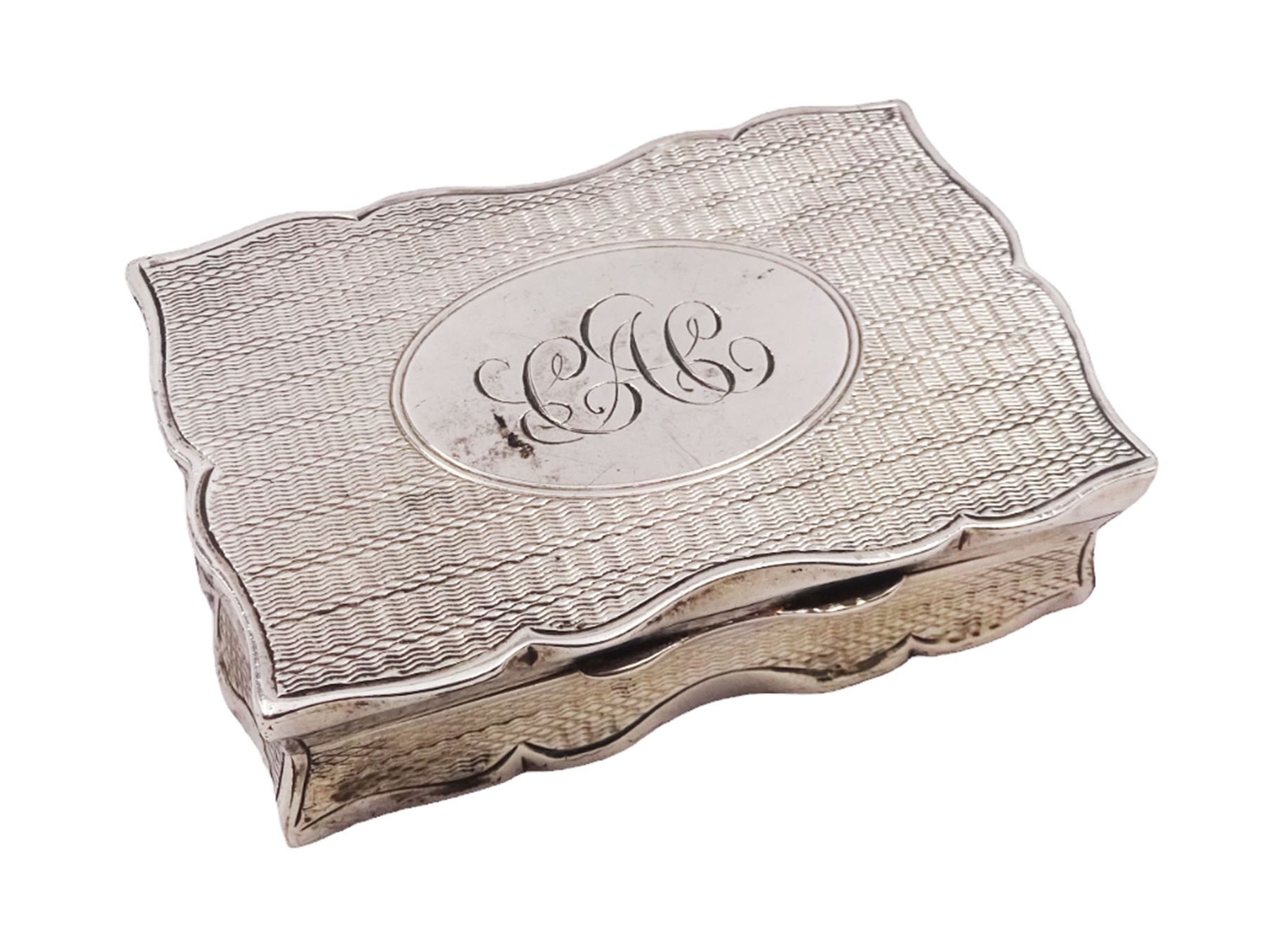 Edwardian silver snuff box, of rectangular form, with shaped edges, engine turned decoration throughout and engraved cartouche to hinged cover, opening to reveal a gilt interior, hallmarked Henry Charles Freeman, Birmingham 1904, W6cm