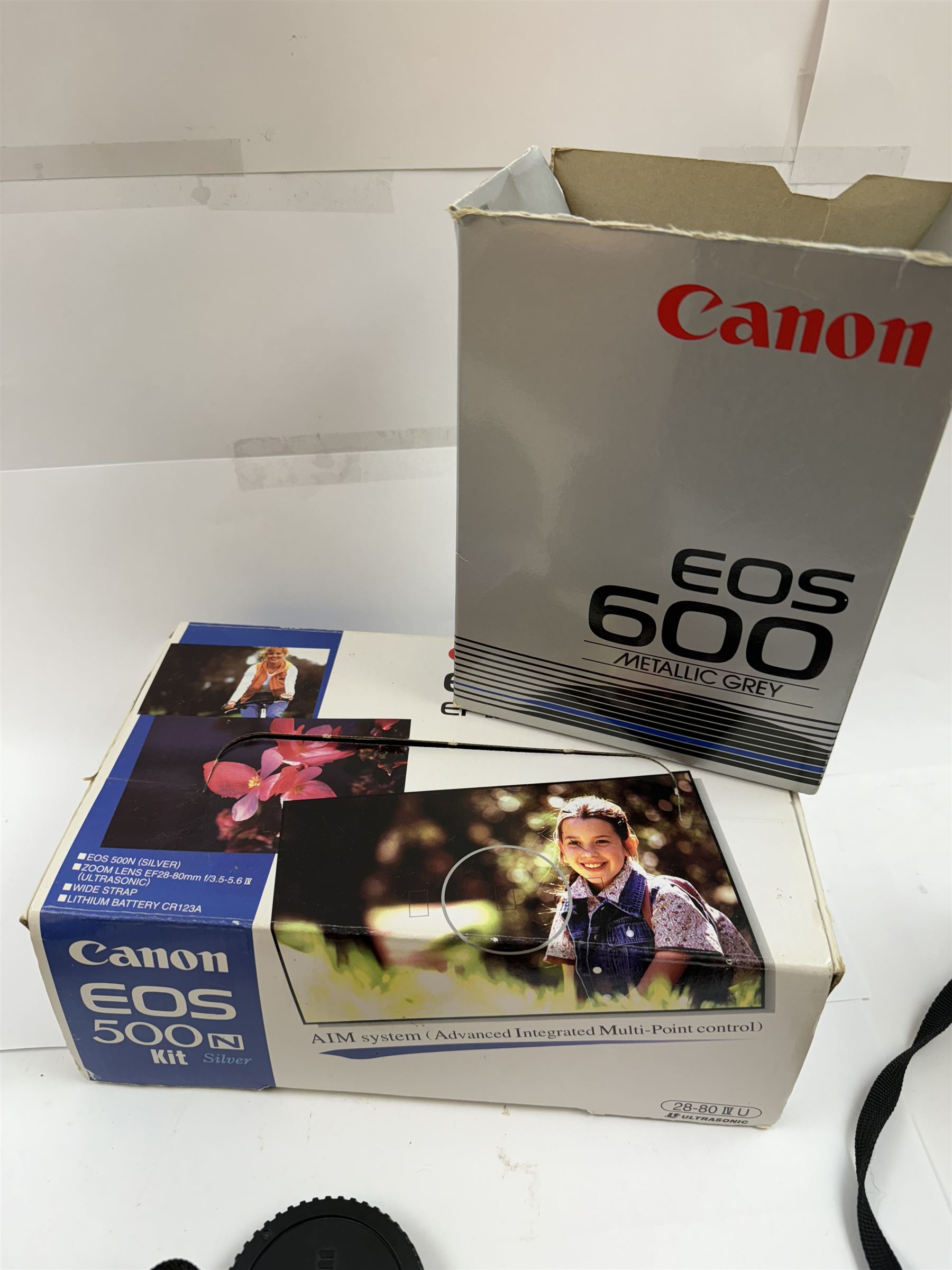 Three Canon EOS cameras, comprising EOS 500N Silver Kit, serial no. 9660130 with Canon EF 28-80mm 1:3.5-5.6 IV zoom lens, serial no. 9505171, EOS 300 with Canon EF 28-90mm 1:4-5.6 zoom lens, serial no. 5828460, and a Sigma 28-300mm 1:3.5-6.3 macro zoom lens, serial no. 1027931 and an EOS 600 camera body, serial no. 2651130, two boxed and one in carry case