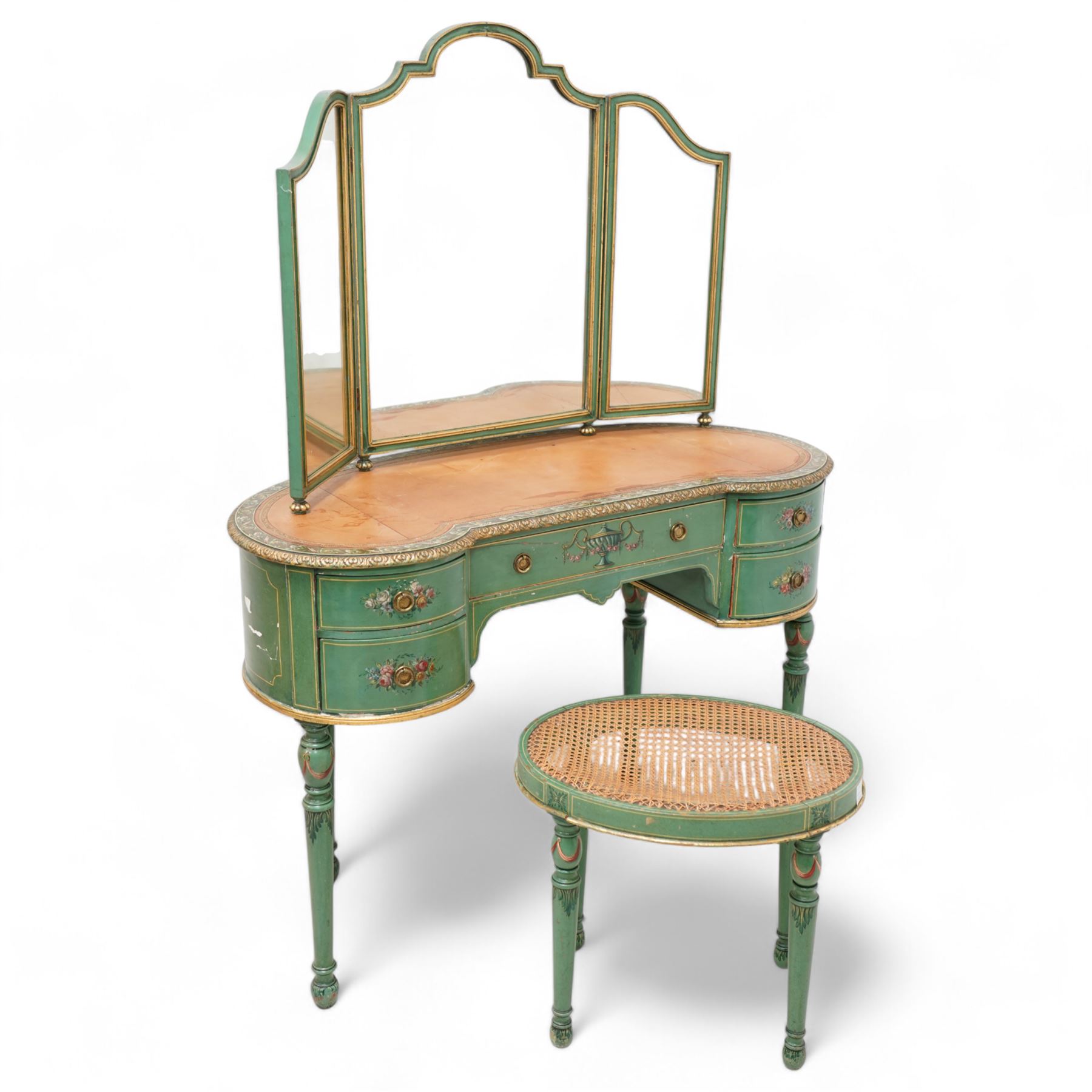 Edwardian Adam Revival green-painted and parcel gilt kidney-shaped dressing table, raised triple mirror back with shaped cresting, leather inset top within a trailing floral painted band and foliate carved edge, fitted with five drawers decorated with urn and floral bouquets, on turned supports painted with acanthus leaves and draped festoons; together with matching stool with cane seat 