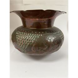 Middle eastern copper bucket, with chased and embossed band of animal decoration, together with a copper jardinière embossed with floral panels, copper plate with embossed leaf motif and two brass helmet shaped coal scuttles, bucket H26cm