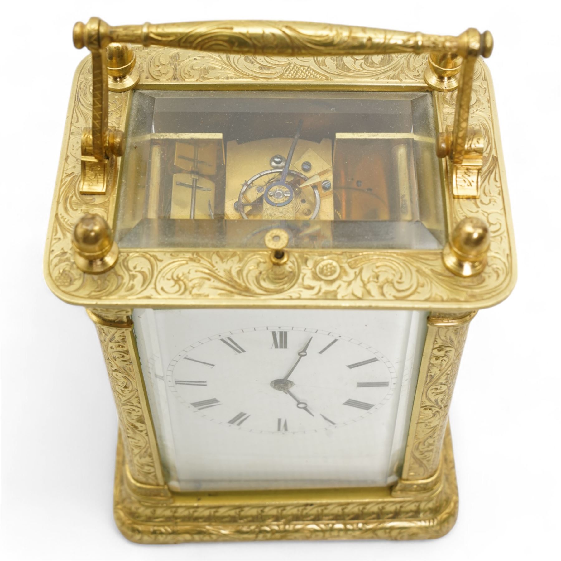 Auguste of Paris - mid-19th century carriage clock in a foliate engraved case with acorn finials and conforming carrying handle, white enamel dial with makers name, Roman numerals, minute track and fine matching steel moon hands,  engraved rear door revealing a twin train going barrel movement striking the hours and half hours on a bell, with the original jewelled lever platform escapement and repeat function, back plate stamped Auguste-Paris, 