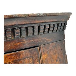 Georgian oak corner cabinet, projecting cornice with shaped dentil frieze, over two panelled doors enclosing three shelves, on a plain plinth base