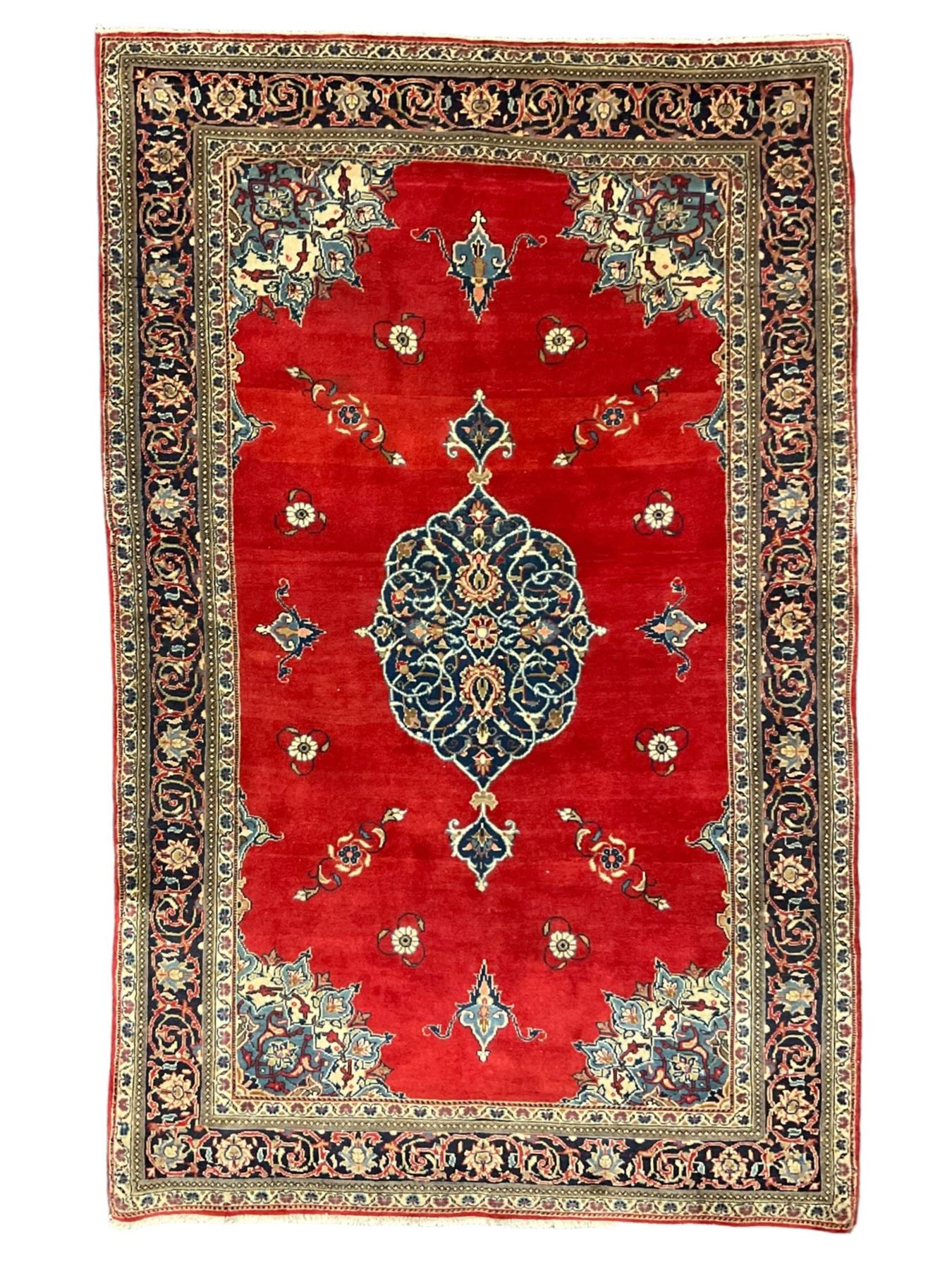 Persian Kashan crimson ground rug, the field decorated with interlacing medallion, floral design spandrels, guarded border with scrolling design decorated with stylised plant motifs